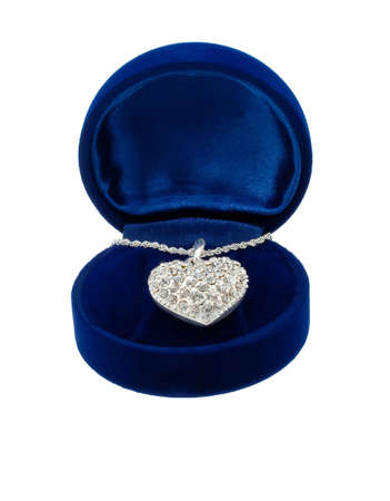 Chain with a brooch in form of heart in blue present box on white backgroundの写真素材