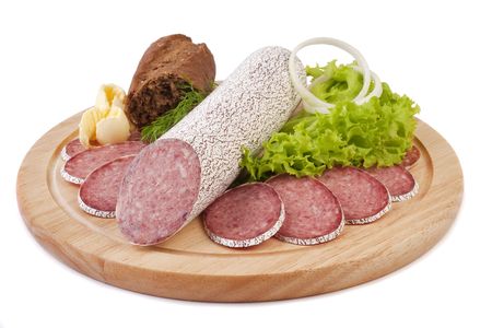 Sliced sausage with rye bread, butter and vegetables on a wooden plate isolatedの写真素材