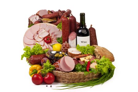 A composition of meat and vegetables with a bottle of wine isolated on white. の写真素材