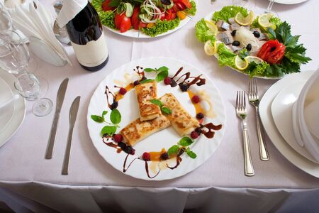 Celebratory table with tasty dishes set for a dinner の写真素材