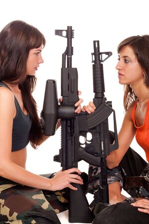 Two girls with a rifles posing to the cameraの写真素材
