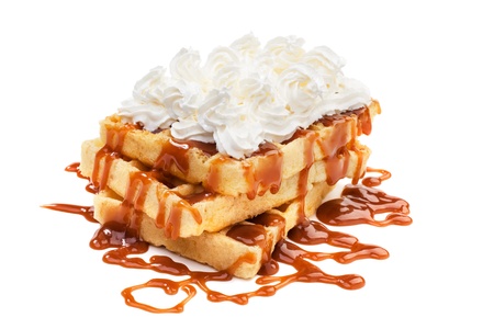 Belgian waffels under the caramel topping with cream on topの写真素材