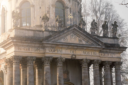 Old rotonda church in the village among autumn trees.の写真素材