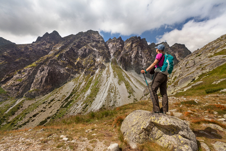 Hiking woman admiring the beauty of rocky Tatra mountainsの写真素材