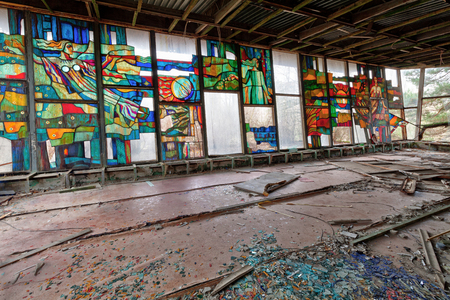 Stained glass inside of abandoned and ruined building of river port in overgrown ghost city Pripyat.の写真素材