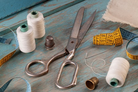 Retro sewing accessories on blue wooden backgroundの写真素材