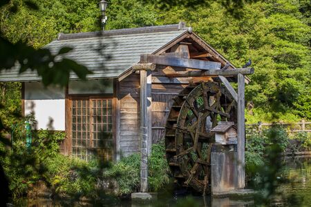 Old wooden mill in a Japanese-style park in downtown Tokyo