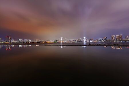Night view on Tokyo skyline towards Rainbow Bridge.の写真素材