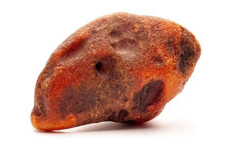 Natural amber. A piece of yellow opaque natural amber on white background.の写真素材