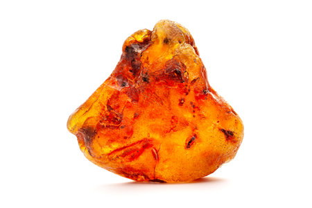 Natural amber. A piece of yellow opaque natural amber on white background.の写真素材