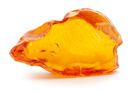 Natural amber. A piece of yellow opaque natural amber on white background.の写真素材