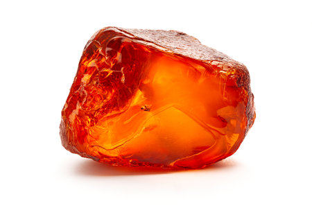 Natural amber. A piece of yellow opaque natural amber on white background.の写真素材