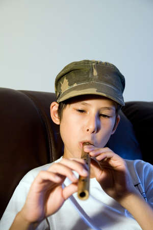 child playing on the fluteの写真素材