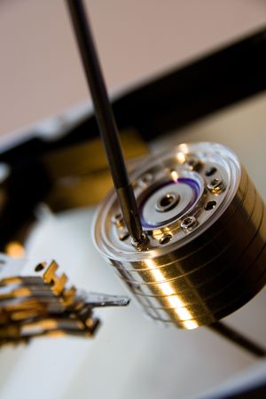 closeup of open harddisk with a screwdriverの写真素材