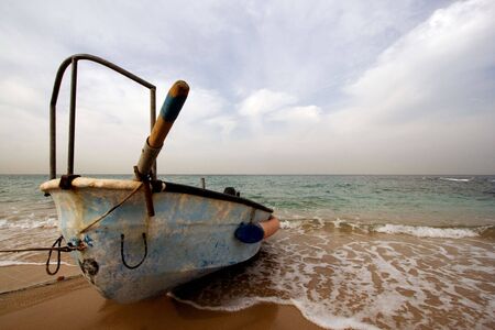 old boat on the empty shoreの写真素材