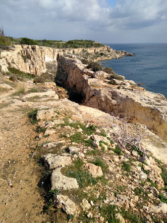 Malta seashore rock cliff view with blue sunny sky and clouds.の写真素材