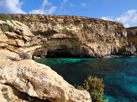 Comino island blue lagoon. Malta blue turquoise sea water beach. Rock and cliff sunny seashore. Travel mediterranean.の写真素材