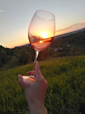 Swirl wine outdoor with handの写真素材