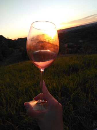 Swirl wine outdoor with handの写真素材