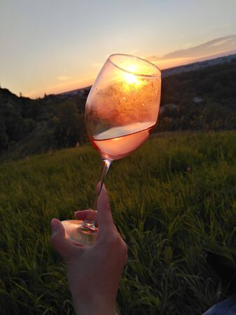 Swirl wine outdoor with handの写真素材