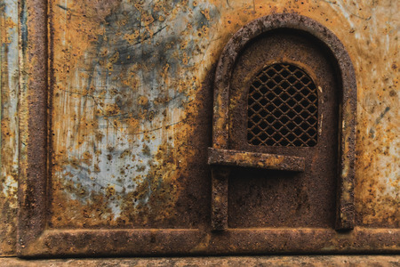 Rusty texture of a metal box with a small door.の写真素材