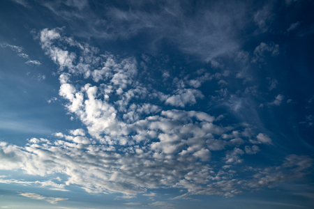 Dramatic evening clouds with in a vivid blue skyの写真素材