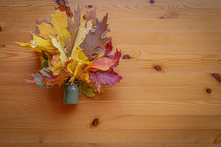 Flat lay wooden table background with autumn leaves