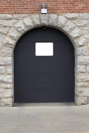 Building entrance into brick building, blank sign aboveの写真素材