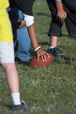 Children playing peewee football at local parkの写真素材