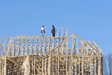 New building under construction, carpenters installing frame work