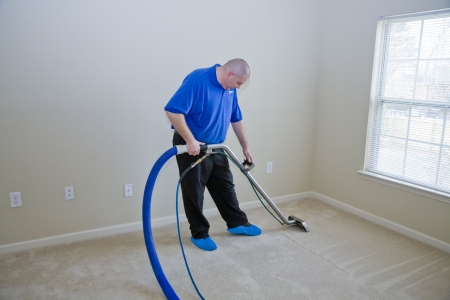 Man cleaning carpet with commercial cleaning equipment Man cleaning carpet with commercial cleaning equipment