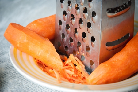 Carrot and grater for vegetables closeupの写真素材