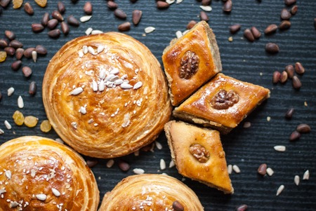 Eastern sweets. Pastry and different nuts on dark background