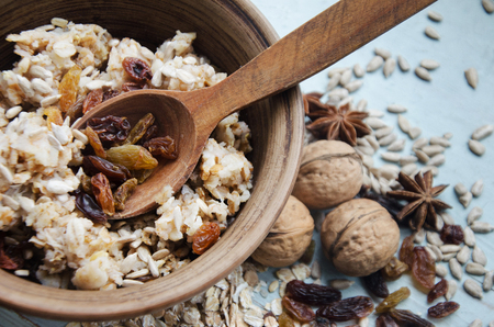 Close up image of bowl of healthy gluten free oatmeal with nuts and raisinsの写真素材