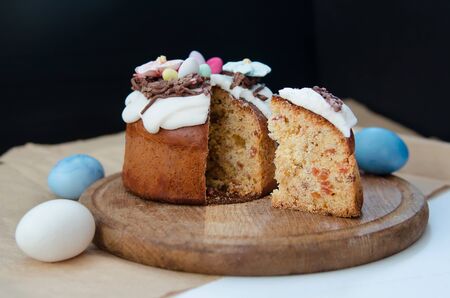 Festive Easter cake with flower decorations and cuted slice of cake