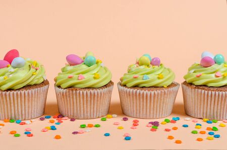 Row of bright pistachio Easter cupcakes with decorations close upの写真素材