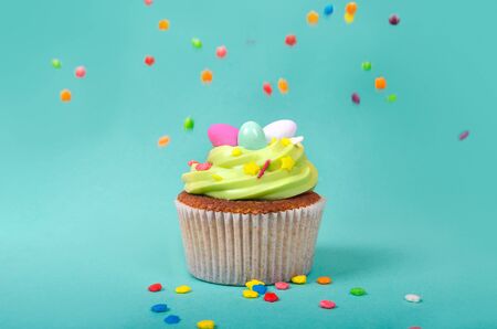 Bright pistachio Easter cupcake with decorations close up