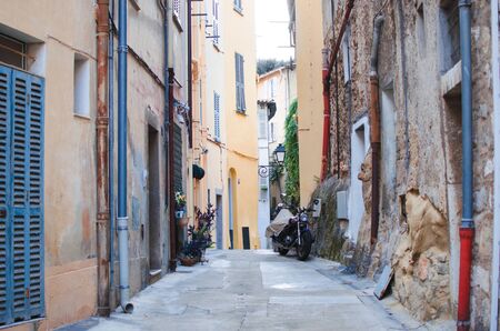 Typical colorful narrow street with blue doors in Menton, Franceの写真素材