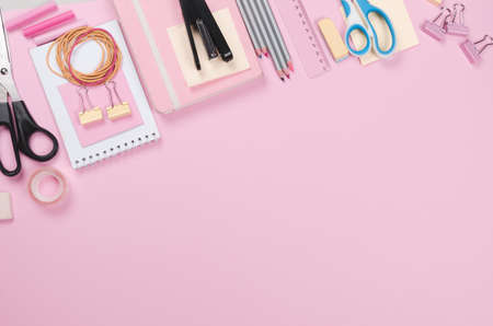 Different school supplies on light pink background