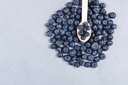 Close up bog bilberries on a wooden spoon. Healthy nutrition conceptの写真素材