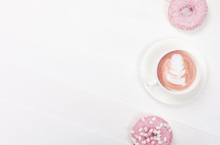 Flat lay composition with donuts and cup of coffee on white backgroundの写真素材