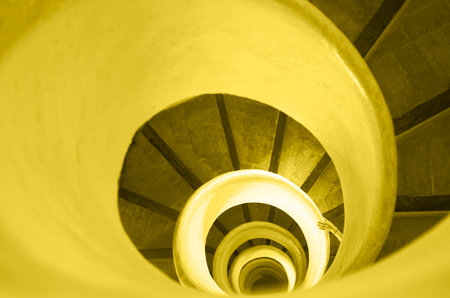Yellow and gray, Color of the year of 2021 Illuminating. Old stairs in spiral staircase with handの写真素材