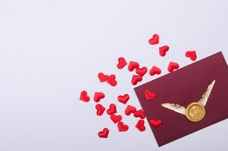 Envelope with love letter and red heart shape confetti. Valentines day , flat-lay, top viewの写真素材
