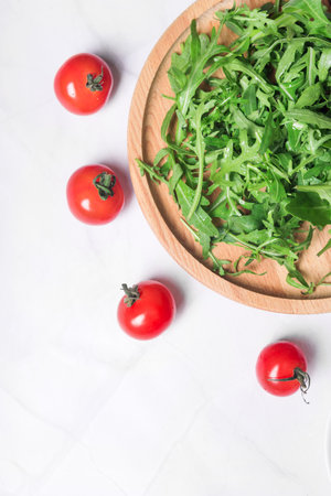 Fresh organic tomatoes for healthy food cooking on light stone background top view mock upの写真素材