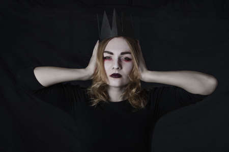 Women in halloween costume with crown in studioの写真素材