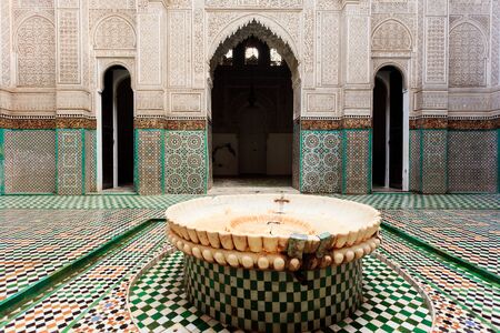 Meknes, Morocco: Interior courtyard with closeup of fountain of madrasah Muslim school in Meknes, Morocco.のeditorial素材