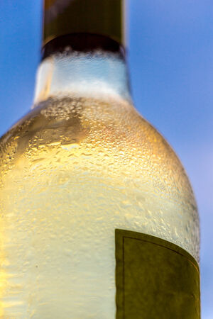 crisp and cool white wine bottle with selective focusの写真素材