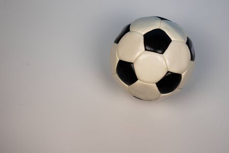 Photo of a soccer ball on a white background. The ball is on the right side.