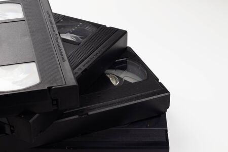 Four video cassettes in a stack on a white background.の写真素材