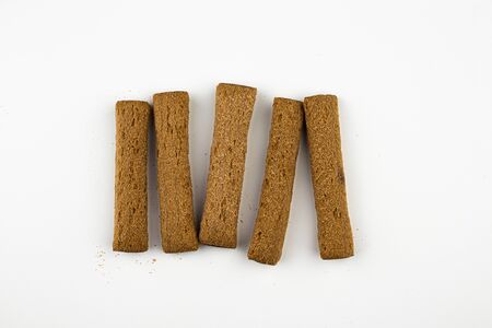 On a white background lie in a row of sweet sticks with stuffing.の写真素材